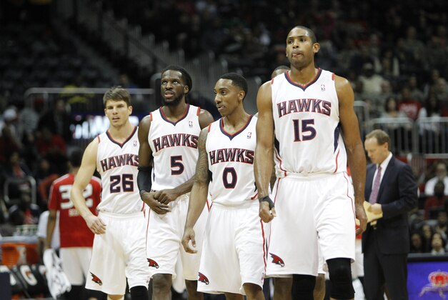 Dec 20, 2013; Atlanta, GA, USA; Atlanta Hawks shooting guard Kyle Korver (26) and small forward DeMarre Carroll (5) and point guard Jeff Teague (0) and center Al Horford (15) walk on the court against the Utah Jazz in the third quarter at Philips Arena. Mandatory Credit: Brett Davis-USA TODAY Sports