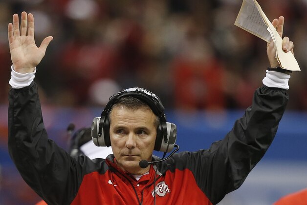 Ohio State head coach Urban Meyer indicates a Ohio State touchdown by wide receiver Michael Thomas in the first half of the Sugar Bowl NCAA college football playoff semifinal game against Alabama, Thursday, Jan. 1, 2015, in New Orleans. (AP Photo/Bill Haber)