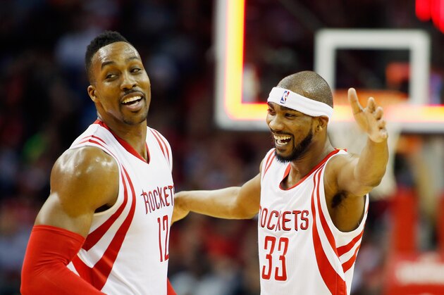 HOUSTON, TX - JANUARY 03:  Dwight Howard #12 (L) and Corey Brewer #33 of the Houston Rockets celebrate a three-point basket during their game against the Miami Heat at the Toyota Center on January 3, 2015 in Houston, Texas.  NOTE TO USER: User expressly acknowledges and agrees that, by downloading and/or using this photograph, user is consenting to the terms and conditions of the Getty Images License Agreement.  (Photo by Scott Halleran/Getty Images)