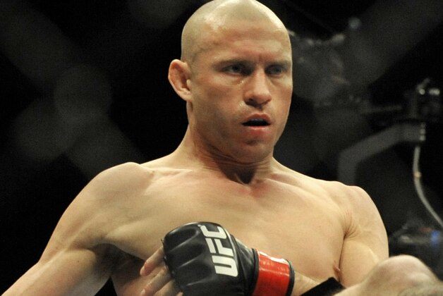 Donald Cerrone left, kicks Adriano Martins right, during the lightweight bout of an UFC mixed martial arts match in Chicago, Saturday, Jan., 25, 2014. (AP Photo/Paul Beaty)