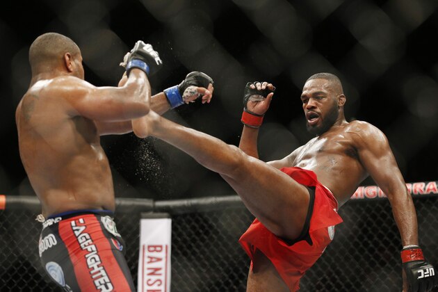 Jon Jones kicks Daniel Cormier during their light heavyweight title mixed martial arts bout at UFC 182, Saturday, Jan. 3, 2015, in Las Vegas. (AP Photo/John Locher)
