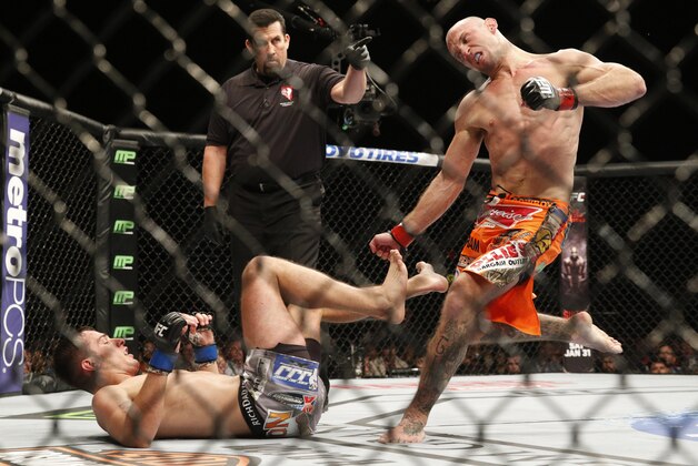 Donald Cerrone kicks Myles Jury during their lightweight mixed martial arts bout at UFC 182, Saturday, Jan. 3, 2015, in Las Vegas. (AP Photo/John Locher)
