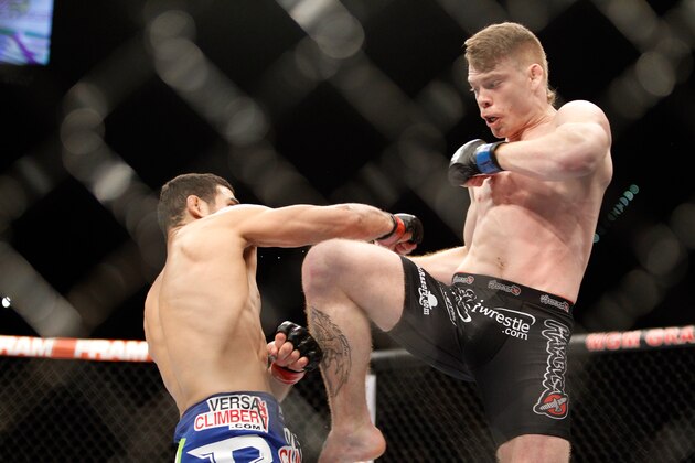 LAS VEGAS, NV - JANUARY 03:  Paul Felder (R) kicks at Danny Castillo in a lightweight bout during the UFC 182 event in the MGM Grand Garden Arena on January 3, 2015 in Las Vegas, Nevada. Felder won with a second-round knockout. (Photo by Steve Marcus/Getty Images)