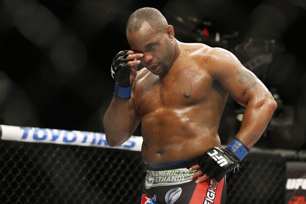 Daniel Cormier rubs his eye after he was poked in the eye by Jon Jones during their light heavyweight title mixed martial arts bout at UFC 182, Saturday, Jan. 3, 2015, in Las Vegas. (AP Photo/John Locher)