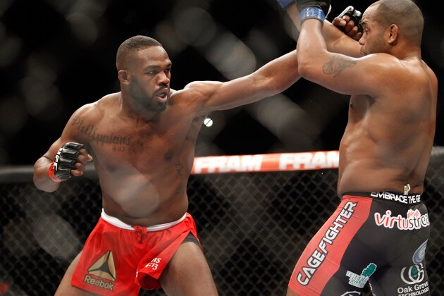 LAS VEGAS, NV - JANUARY 03:  Light heavyweight champion Jon Jones punches at Daniel Comier during the UFC 182 event at the MGM Grand Garden Arena on January 3, 2015 in Las Vegas, Nevada. Jones retained his title by unanimous decision.  (Photo by Steve Marcus/Getty Images)