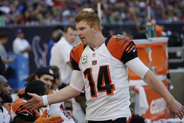Cincinnati Bengals' Andy Dalton (14) talks with teammates on the sideline during the third quarter of an NFL football game against the Houston Texans, Sunday, Nov. 23, 2014, in Houston. (AP Photo/David J. Phillip)