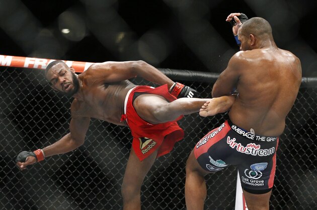 Jon Jones kicks Daniel Cormier during their light heavyweight title mixed martial arts bout at UFC 182, Saturday, Jan. 3, 2015, in Las Vegas. (AP Photo/John Locher)