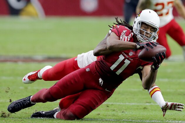 Arizona Cardinals wide receiver Larry Fitzgerald (11) makes a catch against the Kansas City Chiefs during the first half of an NFL football game, Sunday, Dec. 7, 2014, in Glendale, Ariz. (AP Photo/Rick Scuteri)