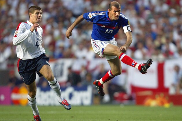 Zinedine Zidane of France, right, takes a shot chased by England's Steven Gerrard during the Euro 2004 Group B soccer match between England and France at Luz Stadium, in Lisbon, Portugal, Sunday June 13, 2004. Switzerland and Croatia are the other teams in Group B. (AP Photo/Lionel Cironneau) ** FOR EDITORIAL USE ONLY; NO WIRELESS, COMMERICAL OR PROMOTIONAL LICENSING PERMITTED **