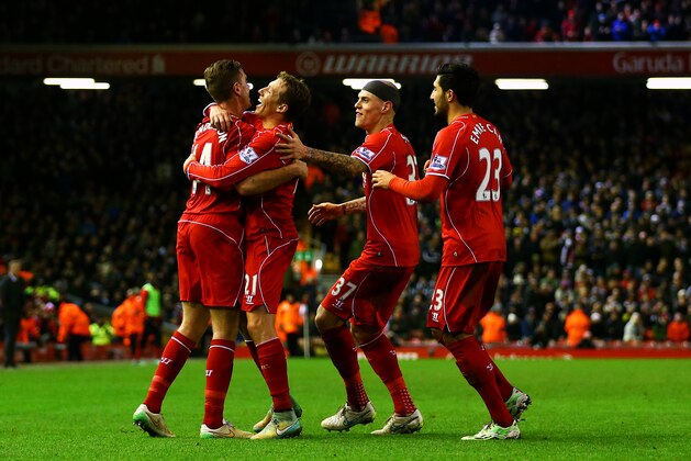 LIVERPOOL, ENGLAND - DECEMBER 29:  Jordan Henderson of Liverpool celebrates with team-mates after Jonjo Shelvey of Swansea City scored an own goal during the Barclays Premier League match between Liverpool and Swansea City at Anfield on December 29, 2014 in Liverpool, England.  (Photo by Clive Brunskill/Getty Images)