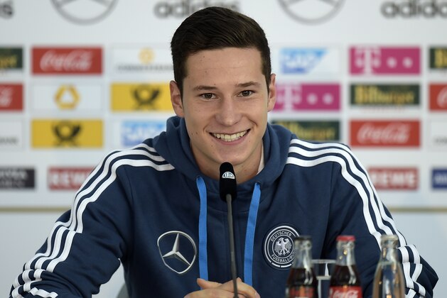 Germany's player Julian Draxler smiles to the media at a press conference in Essen, Germany, Monday, Oct. 13, 2014. Germany will play a Euro 2016 group D qualifying soccer match against Ireland on Tuesday in Gelsenkirchen. (AP Photo/Martin Meissner)
