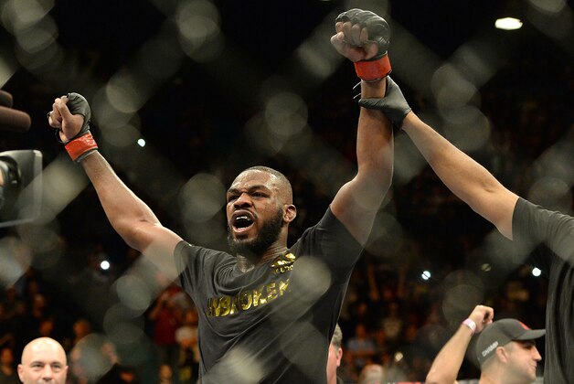 Jan 3, 2015; Las Vegas, NV, USA; Jon Jones (red gloves) celebrates after defeating Daniel Cormier (not pictured) in their light heavyweight title fight at UFC 182 at the MGM Grand Garden Arena. Jones won. Mandatory Credit: Jayne Kamin-Oncea-USA TODAY Sports