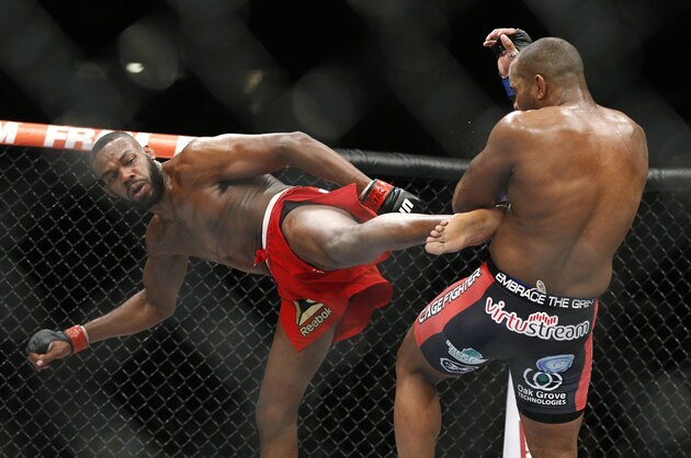 Jon Jones kicks Daniel Cormier during their light heavyweight title mixed martial arts bout at UFC 182, Saturday, Jan. 3, 2015, in Las Vegas. (AP Photo/John Locher)