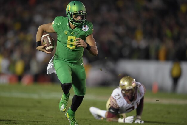 Jan 1, 2015; Pasadena, CA, USA; Oregon Ducks quarterback Marcus Mariota (8) scores on a 23-yard touchdown run in the fourth quarter against the Florida State Seminoles in the 2015 Rose Bowl college football game at Rose Bowl. Oregoon defeated Florida State 59-20. Mandatory Credit: Kirby Lee-USA TODAY Sports
