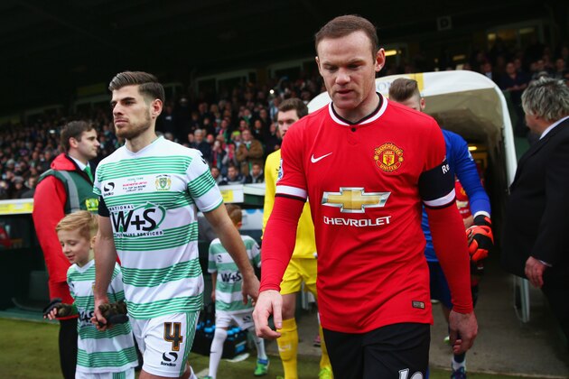 YEOVIL, ENGLAND - JANUARY 04:  Captains Sam Hoskins of Yeovil Town (L) and Wayne Rooney of Manchester United lead out the teams prior to the FA Cup Third Round match between Yeovil Town and Manchester United at Huish Park on January 4, 2015 in Yeovil, England.  (Photo by Michael Steele/Getty Images)