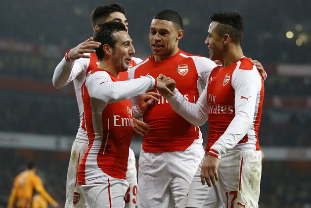 Arsenal's Alexis Sanchez, right, celebrates scoring a goal with  Santi Cazorla, left, during the English FA Cup third round soccer match between Arsenal and Hull City at the Emirates Stadium in London, Sunday, Jan. 4, 2015. (AP Photo/Kirsty Wigglesworth)