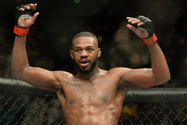 Jan 3, 2015; Las Vegas, NV, USA; Jon Jones (red gloves) celebrates after defeating Daniel Cormier (not pictured) in their light heavyweight title fight at UFC 182 at the MGM Grand Garden Arena. Jones won. Mandatory Credit: Jayne Kamin-Oncea-USA TODAY Sports