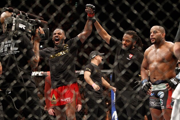 LAS VEGAS, NV - JANUARY 03:  Jon Jones (L) celebrates after defeating Daniel Comier (R) during their light heavyweight title fight at the MGM Grand Garden Arena on January 3, 2015 in Las Vegas, Nevada. Jones retained his title by unanimous decison. (Photo by Steve Marcus/Getty Images)