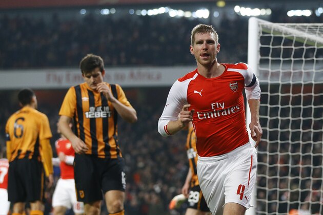 Arsenal's Per Mertesacker celebrates scoring his side's first goal during the English FA Cup third round soccer match between Arsenal and Hull City at the Emirates Stadium in London, Sunday, Jan. 4, 2015. (AP Photo/Kirsty Wigglesworth)