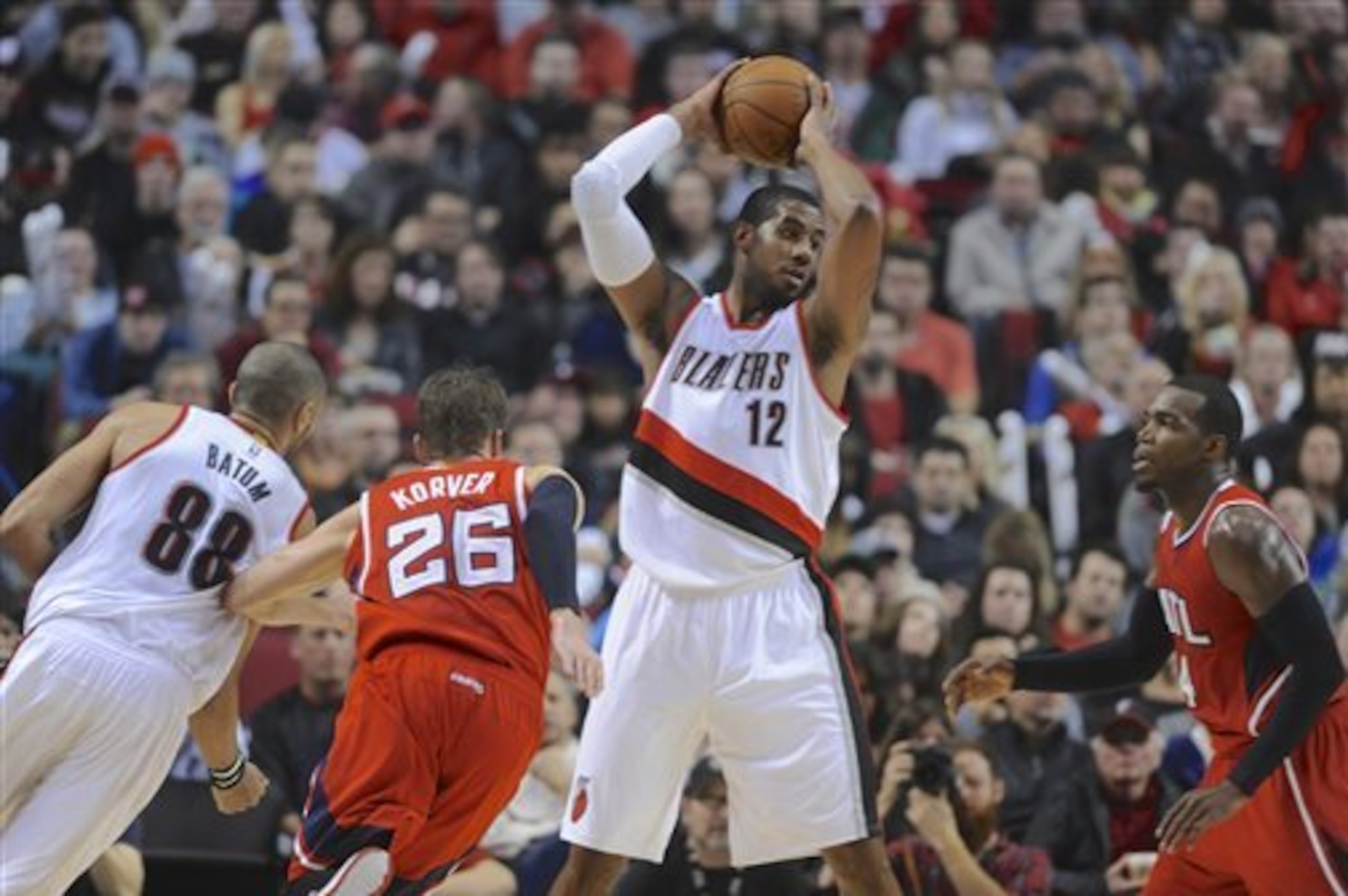 Atlanta Hawks' Paul Millsap, right, defends Portland Trail Blazers' LaMarcus Aldridge (12) during the second half of an NBA  basketball game in Portland, Ore., Saturday, Jan. 3, 2015. The Hawks beat the Trail Blazers 115-107. (AP Photo/Greg Wahl-Stephens)