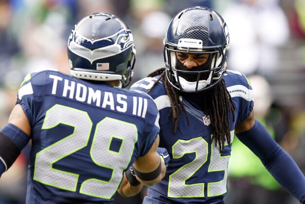 Dec 28, 2014; Seattle, WA, USA; Seattle Seahawks cornerback Richard Sherman (25) shakes hands with Seattle Seahawks free safety Earl Thomas (29) during pre game warmups against the St. Louis Rams at CenturyLink Field. Mandatory Credit: Joe Nicholson-USA TODAY Sports