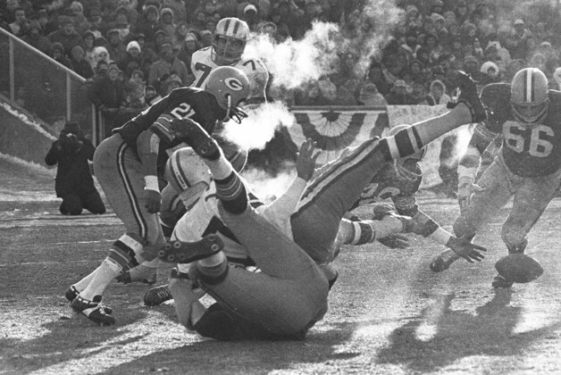 FILE - In this Dec. 31, 1967 file photo, players spill in all directions as a fumble occurs in the third period of the National Football League Championship game, known as