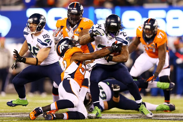 EAST RUTHERFORD, NJ - FEBRUARY 02: Running back Marshawn Lynch #24 of the Seattle Seahawks  runs the ball during Super Bowl XLVIII against the Denver Broncos  at MetLife Stadium on February 2, 2014 in East Rutherford, New Jersey.  (Photo by Elsa/Getty Images)