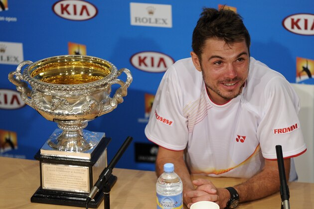 Stanislas Wawrinka of Switzerland speaks next to the trophy,  during a press conference after defeating Rafael Nadal of Spain in the men's singles final at the Australian Open tennis championship in Melbourne, Australia, Sunday, Jan. 26, 2014.(AP Photo/Andrew Brownbill)