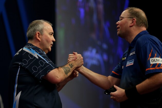 LONDON, ENGLAND - JANUARY 03:   Phil Taylor of England and  Raymond van Barneveld of the Netherlands shake hands after their semi final match on day thirteen of the 2015 William Hill PDC World Darts Championships at Alexandra Palace on January 3, 2015 in London, England.  (Photo by Ben Hoskins/Getty Images)