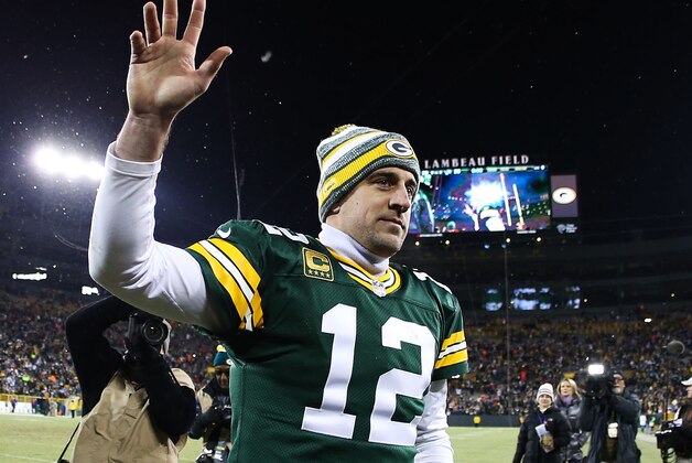 GREEN BAY, WI - DECEMBER 28:  Aaron Rodgers #12 of the Green Bay Packers waves to fans as he walks off of the field after defeating the Detroit Lions 30 to 20 to take the NFC North Championship at Lambeau Field on December 28, 2014 in Green Bay, Wisconsin.  (Photo by Chris Graythen/Getty Images)