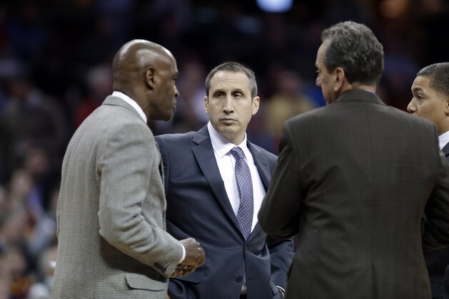 Cleveland Cavaliers head coach David Blatt, center, confers with his assistants in the third quarter of an NBA basketball game against the Atlanta Hawks Wednesday, Dec. 17, 2014, in Cleveland. (AP Photo/Mark Duncan)