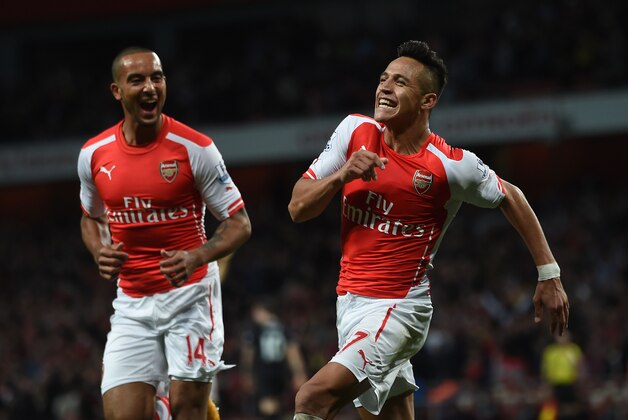 Arsenal’s Alexis Sanchez, right, celebrates scoring his side's third goal with teammate Theo Walcott during their English Premier League soccer match against Burnley at the Emirates stadium, London, Saturday, Nov. 1, 2014. (AP Photo/Tim Ireland)