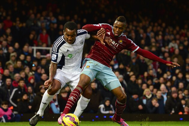 LONDON, ENGLAND - JANUARY 01:  Diafra Sakho of West Ham United challenges Andre Wisdom of West Bromwich Albion during the Barclays Premier League match between West Ham United and West Bromwich Albion at Boleyn Ground on January 1, 2015 in London, England.  (Photo by Jamie McDonald/Getty Images)