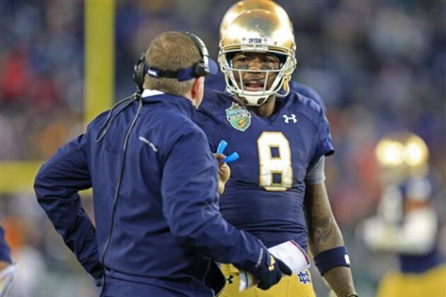 Notre Dame quarterback Malik Zaire (8) talks with coach Brian Kelly during the second half of the Music City Bowl NCAA college football game against LSU on Tuesday, Dec. 30, 2014, in Nashville, Tenn. Notre Dame beat LSU 31-28. (AP Photo/Mark Humphrey)