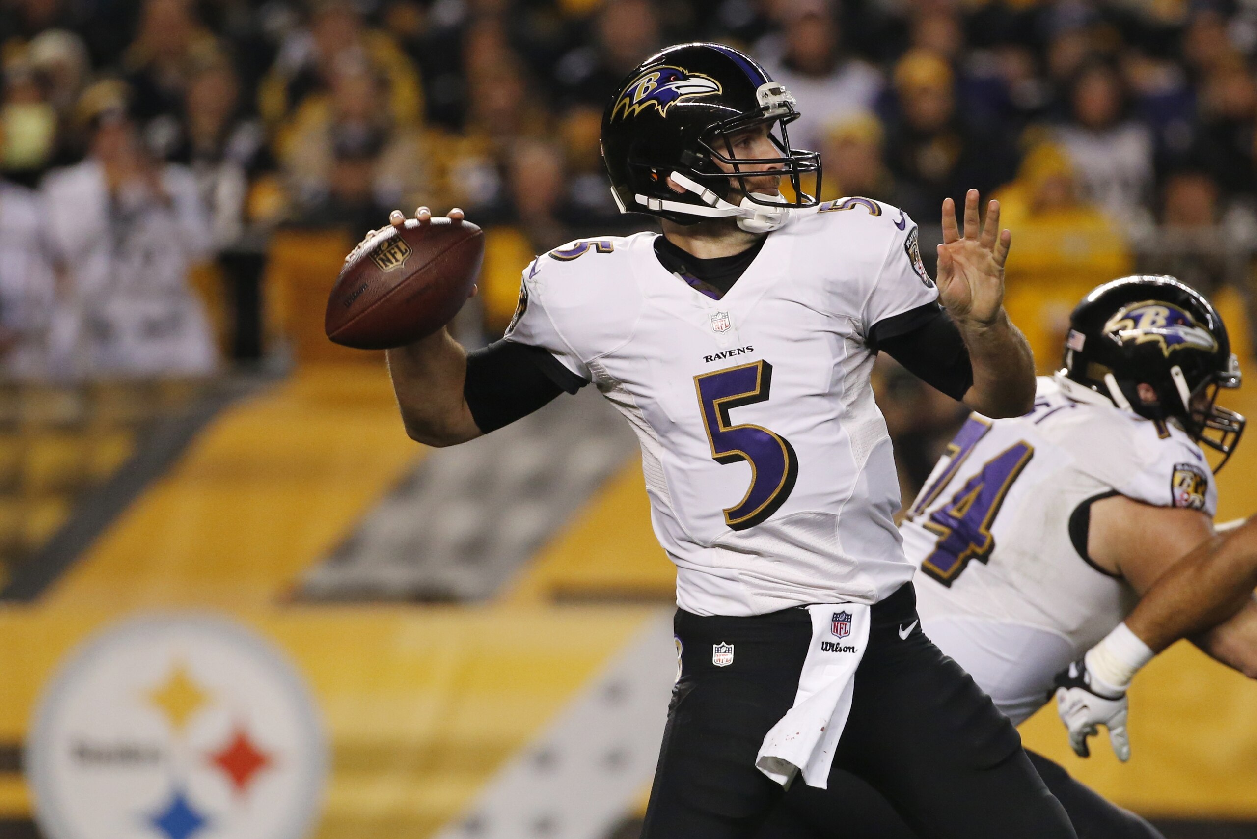 Baltimore Ravens quarterback Joe Flacco (5) passes in the second quarter of an NFL wildcard playoff football game against the Pittsburgh Steelers, Saturday, Jan. 3, 2015, in Pittsburgh. (AP Photo/Gene J. Puskar)