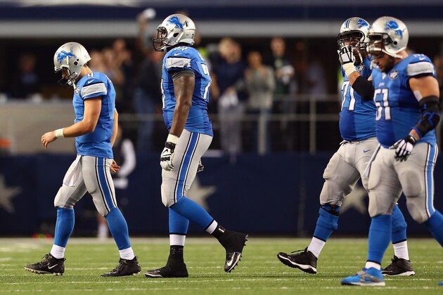 ARLINGTON, TX - JANUARY 04:   Matthew Stafford #9 of the Detroit Lions and the offense walk off the field after a fourth down attempt against the Dallas Cowboys in the fourth quarter during their NFC Wild Card Playoff game at AT&T Stadium on January 4, 2015 in Arlington, Texas.  (Photo by Ronald Martinez/Getty Images)
