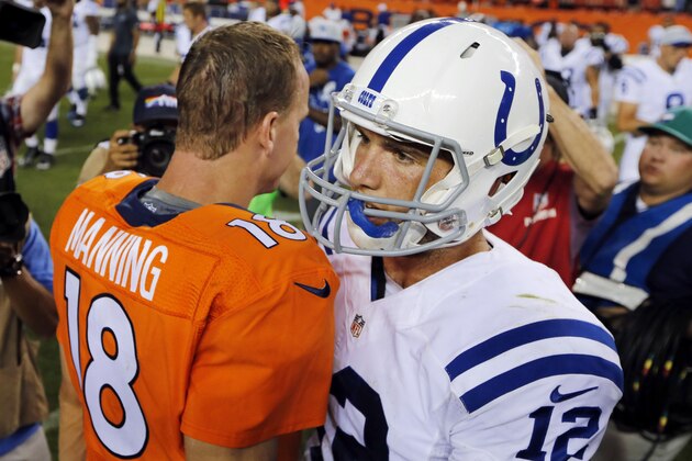 Denver Broncos quarterback Peyton Manning (18) greets Indianapolis Colts quarterback Andrew Luck (12) after an NFL football game, Sunday, Sept. 7, 2014, in Denver. The Broncos won 31-24. (AP Photo/Jack Dempsey)