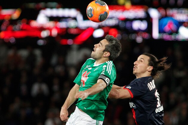 Paris Saint Germain's Zlatan Ibrahimovic, right, challenges Saint Etienne's Loic Perrin for the ball during their French League one soccer match, at the Parc des Princes stadium, in Paris, Sunday, March 16, 2014. (AP Photo/Thibault Camus)