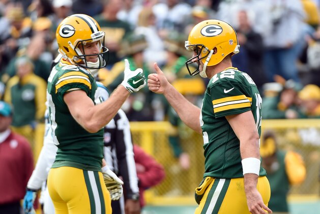 Oct 19, 2014; Green Bay, WI, USA; Green Bay Packers quarterback Aaron Rodgers (right) and wide receiver Jordy Nelson (left) react after a Packers touchdown in the third quarter against the Carolina Panthers at Lambeau Field. The Packers beat the Panthers 38-17. Mandatory Credit: Benny Sieu-USA TODAY Sports