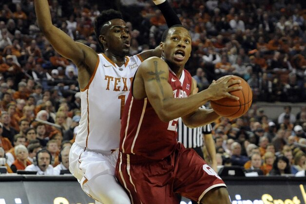 Jan 5, 2015; Austin, TX, USA; Oklahoma Sooners guard Dinjiyl Walker (2) drives against Texas Longhorns guard Isaiah Taylor (1) during the first half at the Frank Erwin Special Events Center. Mandatory Credit: Brendan Maloney-USA TODAY Sports