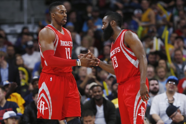 Houston Rockets center Dwight Howard, left, is congratulated after drawing a foul by guard James Harden while facing the Denver Nuggets in the fourth quarter of an NBA basketball game Wednesday, Dec. 17, 2014, in Denver. Houston won 115-111 in overtime. (AP Photo/David Zalubowski)