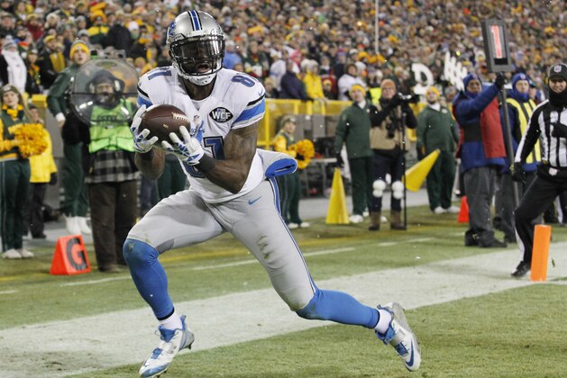 Detroit Lions' Calvin Johnson catches a touchdown pass during the second half of an NFL football game against the Green Bay Packers Sunday, Dec. 28, 2014, in Green Bay, Wis. (AP Photo/Matt Ludtke)