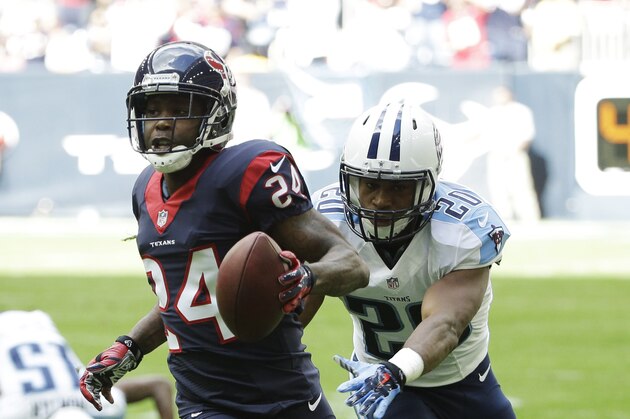 Houston Texans cornerback Johnathan Joseph (24) evades being tackled by Tennessee Titans running back Bishop Sankey during the first half of an NFL football game Sunday, Nov. 30, 2014, in Houston. (AP Photo/David J. Phillip)