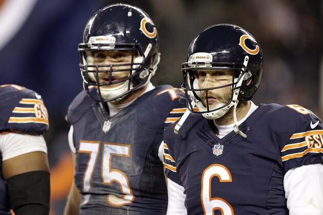 Chicago Bears guard Kyle Long (75) and quarterback Jay Cutler (6) wait for the next play during the second half of an NFL football game against the Dallas Cowboys Thursday, Dec. 4, 2014, in Chicago. (AP Photo/Nam Y. Huh)