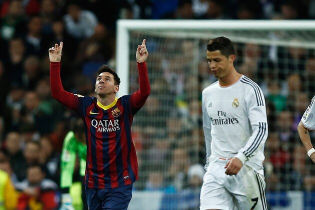 MADRID, SPAIN - MARCH 23:  Lionel Messi (L) of Barcelona celebrates scoring his team's third goal with Neymar (R) of Barcelona as Cristiano Ronaldo and Angel Di Maria of Real Madrid look dejected during the La Liga match between Real Madrid CF and FC Barcelona at the Bernabeu on March 23, 2014 in Madrid, Spain.  (Photo by Gonzalo Arroyo Moreno/Getty Images)