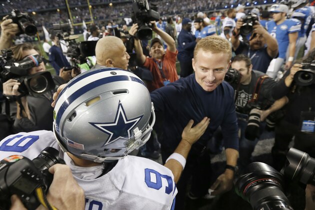 Dallas Cowboys quarterback Tony Romo (9) and head coach Jason Garrett greet after an NFL wildcard playoff football game against the Detroit Lions, Sunday, Jan. 4, 2015, in Arlington, Texas. The Cowboys won 24-20. (AP Photo/Brandon Wade)