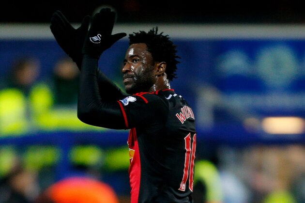 LONDON, ENGLAND - JANUARY 01: Goalscorer Wilfried Bony of Swansea City applauds the travelling fans following their team's 1-1 draw during the Barclays Premier League match between Queens Park Rangers and Swansea City at Loftus Road on January 1, 2015 in London, England. (Photo by Harry Engels/Getty Images) LONDON, ENGLAND - JANUARY 01: Goalscorer Wilfried Bony of Swansea City applauds the travelling fans following their team's 1-1 draw during the Barclays Premier League match between Queens Park Rangers and Swansea City at Loftus Road on January 1, 2015 in London, England. (Photo by Harry Engels/Getty Images)