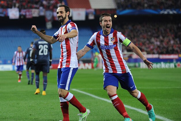 MADRID, SPAIN - NOVEMBER 26:  Gabi Fernandez (R) and Juanfran of Club Atletico de Madrid celebrate after Raul Garcia scoring the team's opening goal during the UEFA Champions League Group A match between Club Atletico de Madrid and Olympiacos FC at Vicente Calderon Stadium on November 26, 2014 in Madrid, Spain.  (Photo by Denis Doyle/Getty Images)