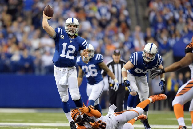 Jan 4, 2015; Indianapolis, IN, USA; Indianapolis Colts quarterback Andrew Luck (12) is pressured by Cincinnati Bengals defensive end Carlos Dunlap (96) during the third quarter in the 2014 AFC Wild Card playoff football game at Lucas Oil Stadium. Mandatory Credit: Kirby Lee-USA TODAY Sports