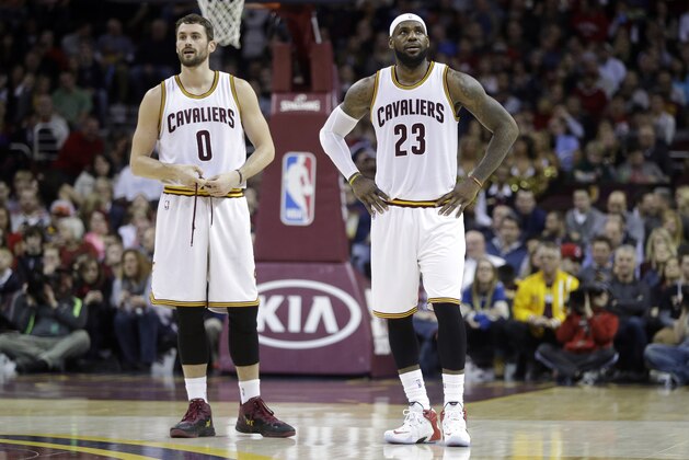 Cleveland Cavaliers' Kevin Love (0) and LeBron James (23) during an NBA basketball game against the Minnesota Timberwolves Tuesday, Dec. 23, 2014, in Cleveland. (AP Photo/Mark Duncan)